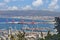 Seaport in the city of Haifa, panorama of the port and city buildings against the background of a blue sky with clouds.