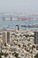 Seaport in the city of Haifa, panorama of the port and city buildings against the background of a blue sky with clouds