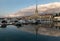 Seaport and its reflection with mooring boats at sunset in Sochi, Russia