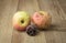 Sear apple and rose still life on wood background