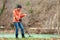 Search With A Metal Detector. The young woman found some treasures near the river. Emotion of joy and surprise