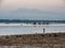 Searching for crabs and shells in front of a vulcano