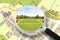 Searching a free Land plot with a vacant land available for building construction - Concept seen through a magnifying glass - note