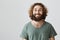 Searching positive in everything. Portrait of happy good-looking eastern husband with curly hair and beard in green t