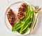 Seared chicken breasts with romaine lettuce leaves