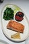 Seared Salmon Fillet Served with Roasted Tomato and Wilted Spinach