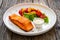 Seared salmon steak with grilled bell pepper and mayonnaise on wooden table