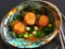 Seared Scallops on nests of roasted Spaghetti Squash, garnished with green peas, blanched kale and green apple cubes, in a brown b