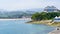 Seascape with area beach, moored boats and green mountains. Suances Santander