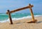 Seascape with bamboo frame on the beach sand