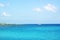 Seascape with coast of Cyprus and cliffs and yacht in distance