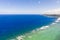 Seascape, coast of the island of Siargao, Philippines. Blue sea with waves and sky with big clouds.