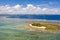 Seascape, coast of the island of Siargao, Philippines. A small island with a white beach and palm trees.