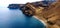 Seascape with coastal volcanic hills and blue wavy water in  La Gomera, Canary Islands, Spain.