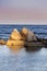 Seascape. Concrete pyramids in the light before sunset.