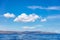 Seascape, Cyclades Greece. Approaching Serifos island from sea. Rocky land, cloud on blue sky