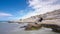 Seascape from the deserted shore to the caspian sea with blue sky and roaring waves