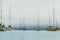Seascape with Docked Sailing Boats. Foggy Overcast Day, and Beautiful Blue Sea