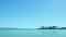 Seascape of egyptian seaside, extreme wide shot. Blue sky is clear. Green palm trees on horizon. Photographed in