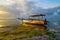 Seascape. Fisherman boat jukung. Traditional fishing boat at the beach during sunset. Cloudy sky. Water reflection. Thomas beach,