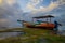 Seascape. Fisherman boat jukung. Traditional fishing boat at the beach during sunset. Cloudy sky. Water reflection. Thomas beach,