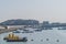 Seascape of fishing trawlers anchored in small harbor under clear blue sky