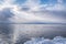 Seascape with a flock of seagulls over the water surface of the bay