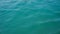 Seascape of the glowing blue green Sea of from a boat looking with small waves and ripples calm sea surface