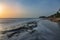 Seascape horizon with rocks in the water and ocean waves at sunrise on Cabarete beach, Dominican Republic