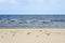 Seascape with a horizontal division into three equal parts, sky, water and sand