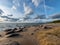 Seascape image of the sea with cloudy sky before sunset,  stones and  of light before sunset, beautiful sunny day and quiet sea.