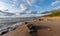 Seascape image of the sea with cloudy sky before sunset,  stones and  of light before sunset, beautiful sunny day and quiet sea.