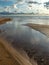 Seascape image of the sea with  stones and grass of light before sunset,  quiet sea