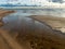 Seascape image of the sea with  stones and grass of light before sunset,  quiet sea