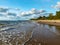 Seascape image of the sea with  stones and grass of light before sunset,  quiet sea