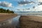 Seascape image of the sea with  stones and grass of light before sunset,  quiet sea