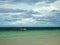 Seascape at Indian ocean, lonely sailboat on the clear blue water