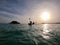 Seascape with kayakers at sunset. silhouette man in the kayak on the ocean in front of dramatic sundown