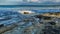 Seascape with large rocks and boulders in sea water sky with clouds before rain wide image