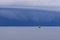 Seascape with large thunderstorm clouds above sea surface with tugboat