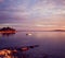 Seascape with Lonely Boat in Sea at Sunset