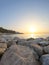 Seascape with Malaga and sunrise sunlight. Sandy beach of the Mediterranean Sea and walking stone pier in Playa de la Caleta,