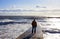 Seascape. Marine landscape with the figure of a man. Wave on the sea breakwater.