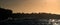 Seascape in the morning.  The colony of seals on the rocky island. Big waves with splashes breaking on a rocky island. South