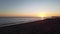 Seascape motion timelapse people walking on shoreline to enjoy beautiful sunset