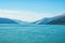 Seascape and mountain landscape on blue sky background in alaska