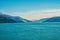 Seascape and mountain landscape on blue sky background in alaska