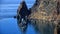 Seascape mountains and rocks a lonely ship on the water