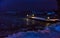 Seascape with night Bay with lights on a pier and reflection