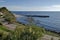 Seascape of pier for fishing boat with coastal road in the Black Sea and small beach near ancient city Nessebar